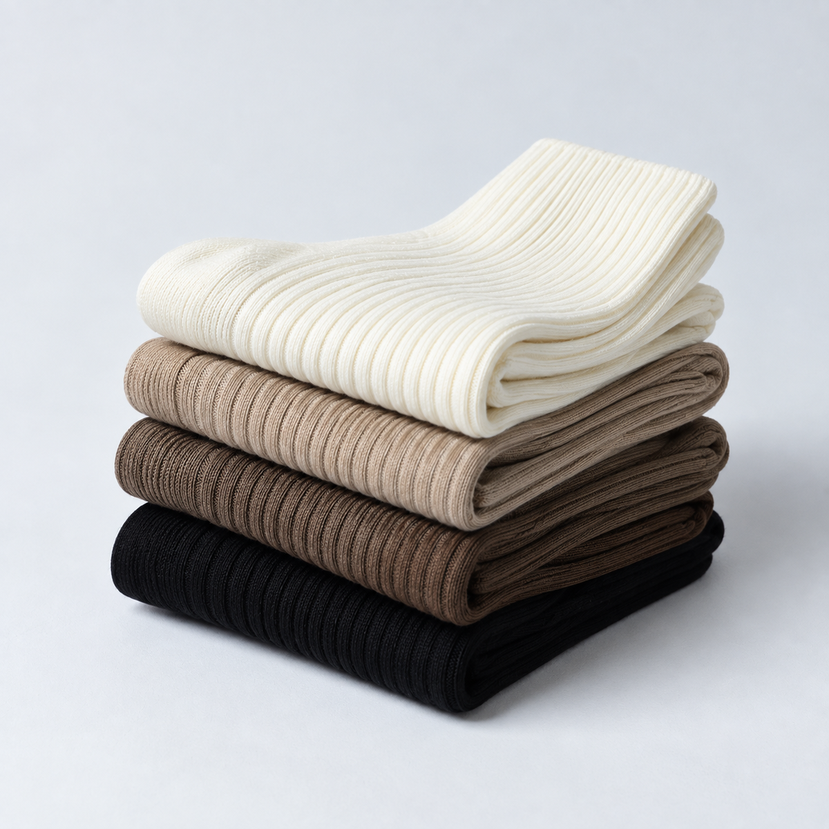 Folded MyBoots Luxury Socks in cream, beige, brown and black.